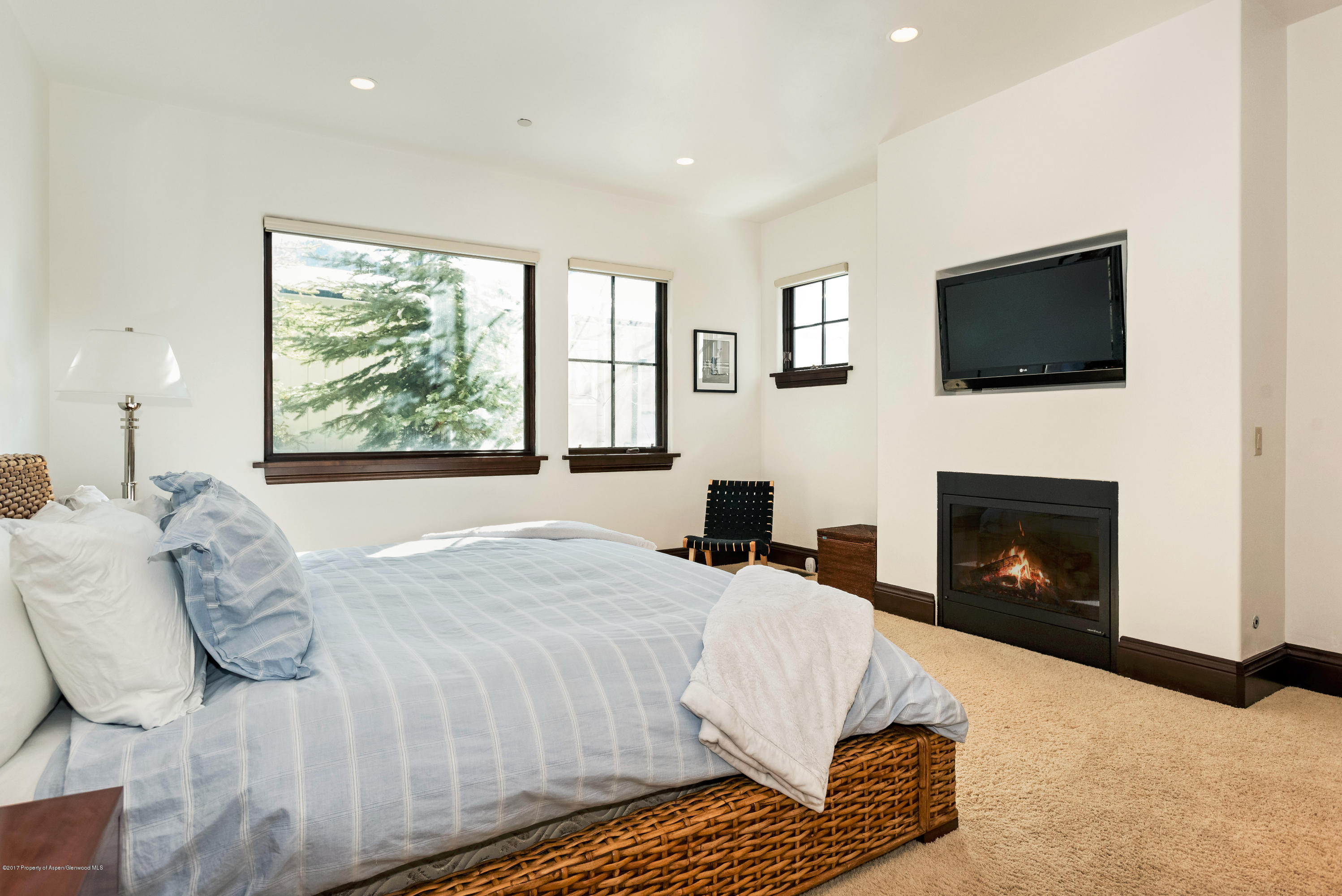 566 Race Street Aspen, CO 81611 - Photo 15 of 26 a living room with a bed a flat screen tv and a fireplace