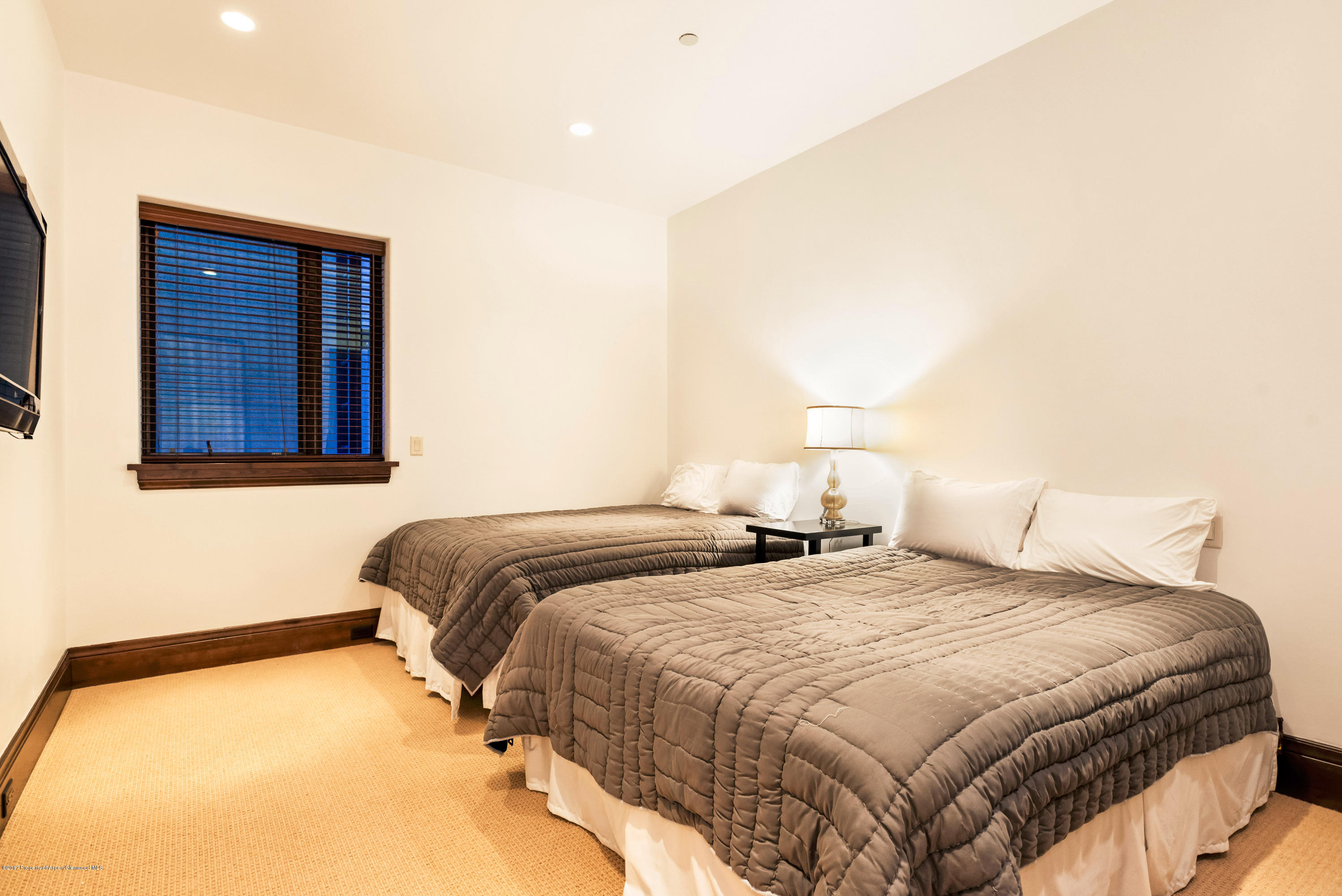 566 Race Street Aspen, CO 81611 - Photo 23 of 26 a bedroom with a bed and a night stand