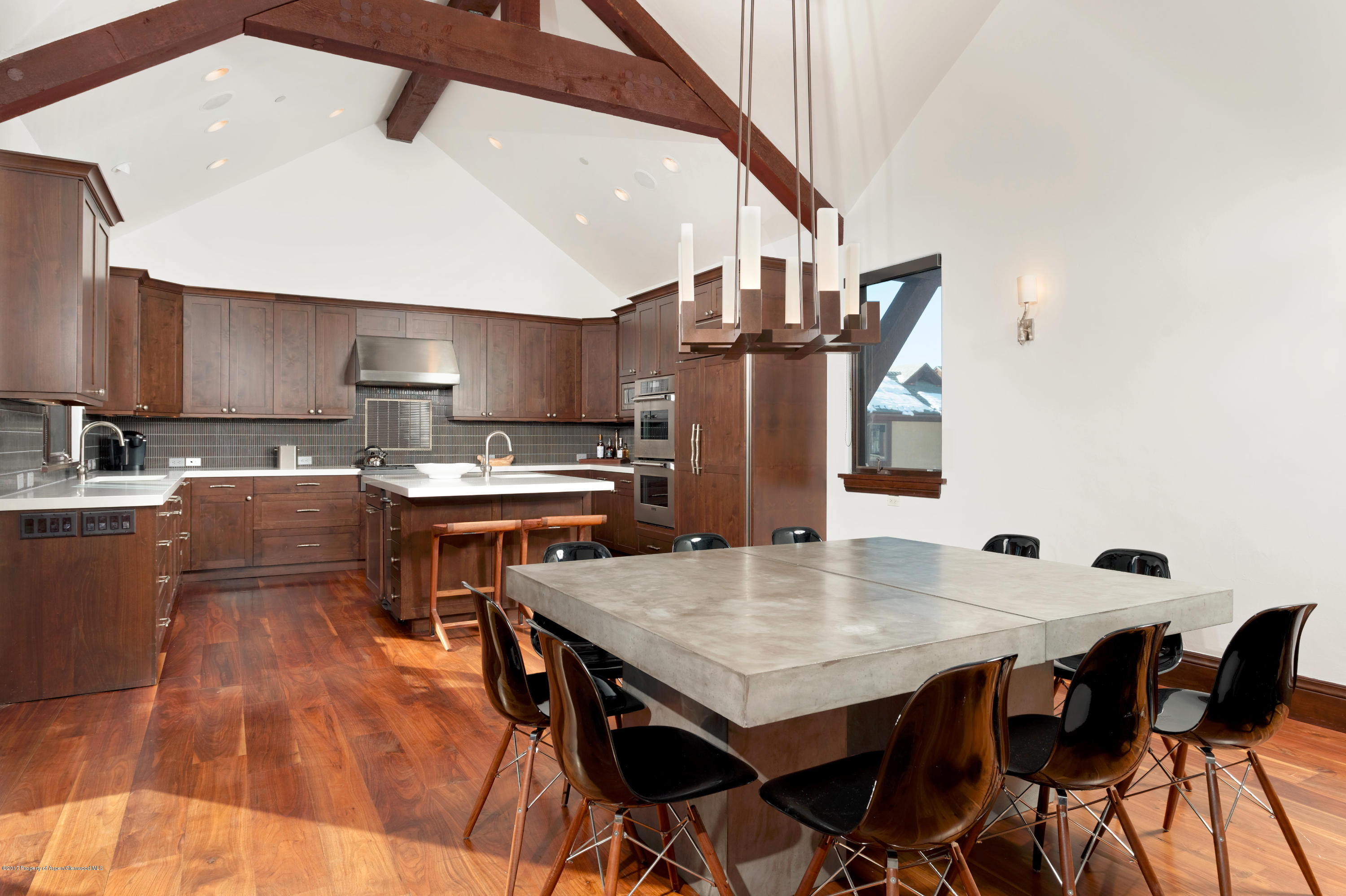 566 Race Street Aspen, CO 81611 - Photo 8 of 26 a open kitchen with stainless steel appliances kitchen island granite countertop a table chairs and a refrigerator
