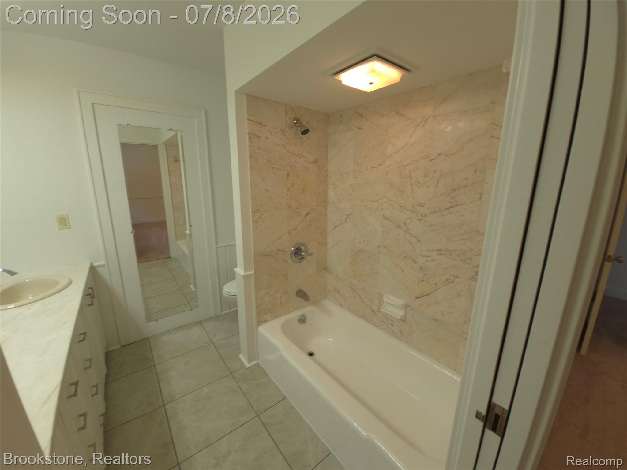 4140 South Henderson Road Davison, MI 48423 - Photo 67 of 98 Full bath featuring a tub/shower combination with patterned wall tile, chrome fixtures, and a ceiling-mounted light fixture