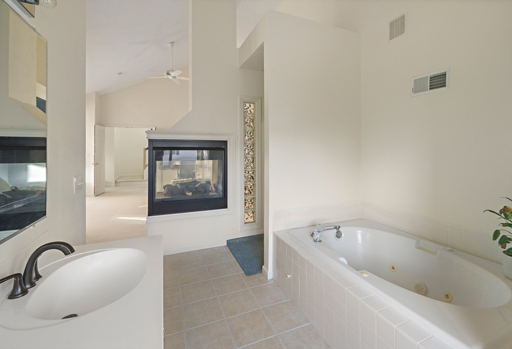 73 Half Crown Circle, Unit 73 Ashland, MA 01721 - Photo 14 of 25 a bathroom with a tub sink and mirror