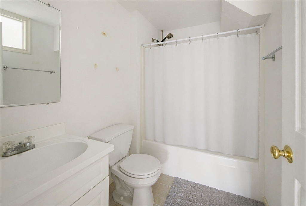 73 Half Crown Circle, Unit 73 Ashland, MA 01721 - Photo 16 of 25 a bathroom with a sink toilet and shower