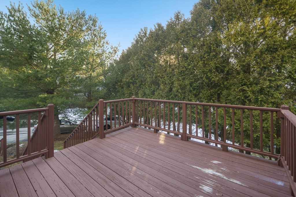 73 Half Crown Circle, Unit 73 Ashland, MA 01721 - Photo 21 of 25 a balcony with wooden floor and fence