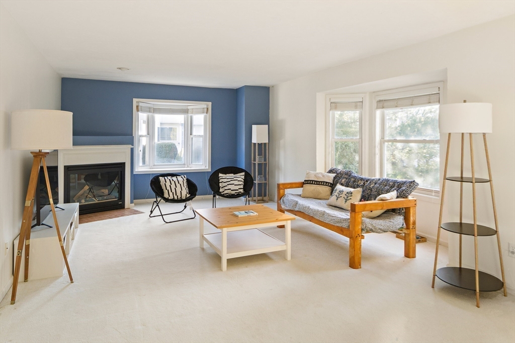 73 Half Crown Circle, Unit 73 Ashland, MA 01721 - Photo 5 of 25 a living room with furniture and a fireplace