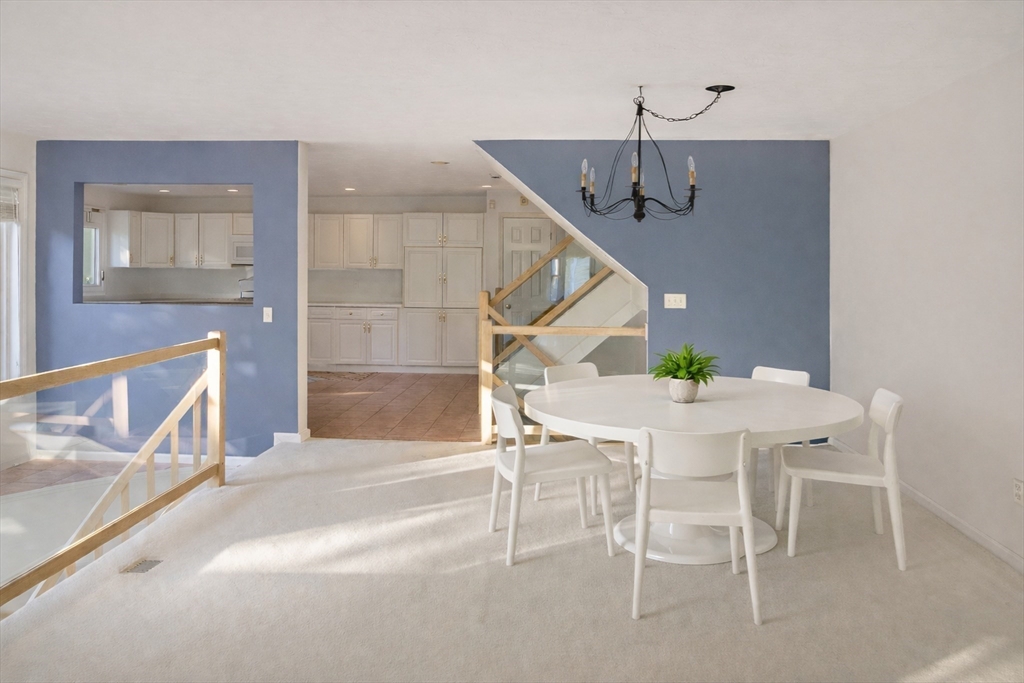 73 Half Crown Circle, Unit 73 Ashland, MA 01721 - Photo 7 of 25 a view of a dining room with furniture and wooden floor