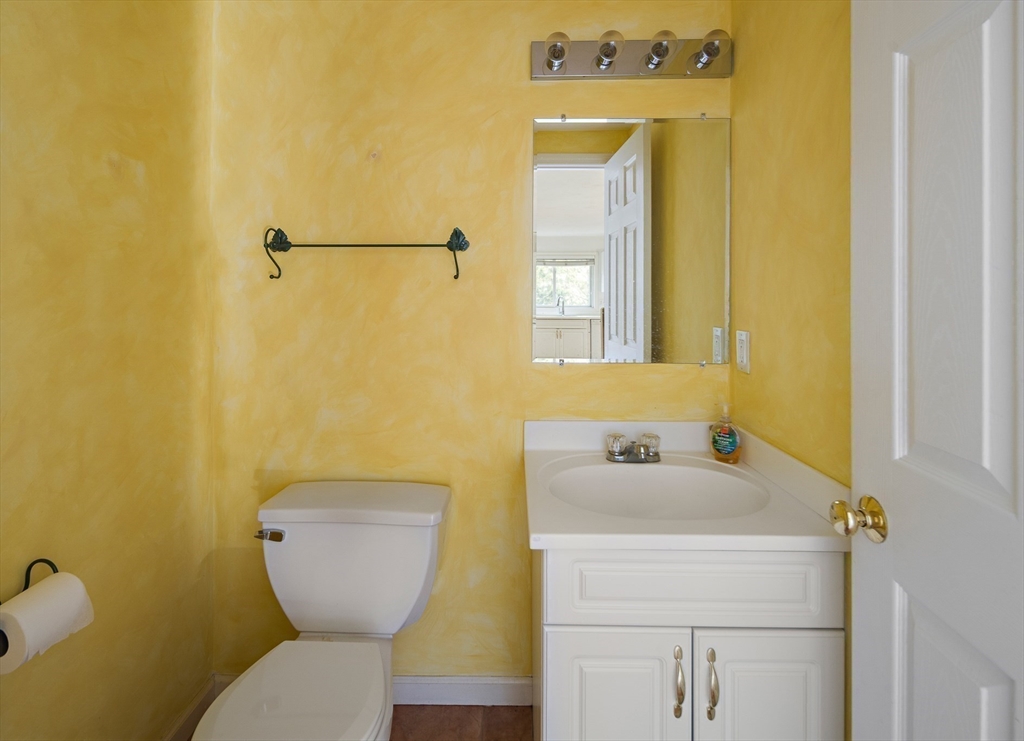 73 Half Crown Circle, Unit 73 Ashland, MA 01721 - Photo 8 of 25 a bathroom with a sink and mirror with toilet