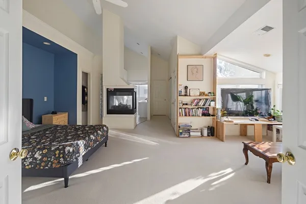 a bedroom with furniture and a large window