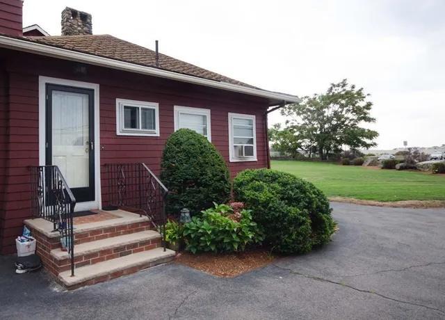 a front view of a house with a garden
