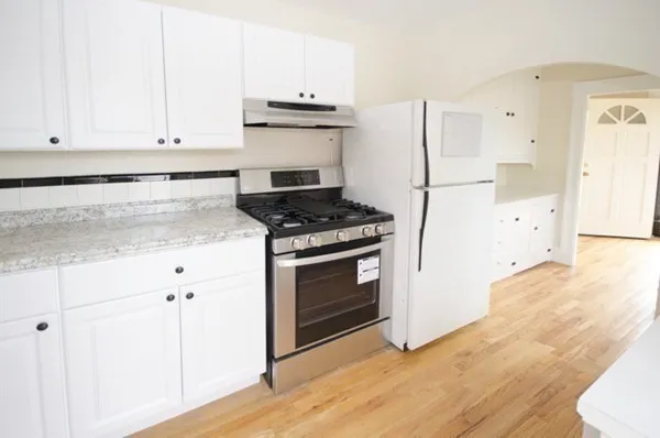 a kitchen with granite countertop a stove and a sink