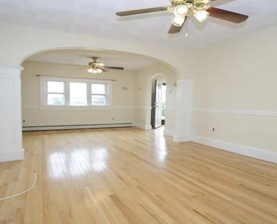 wooden floor in an empty room with a window