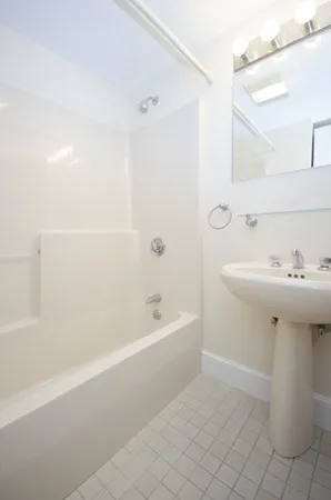 a bathroom with a sink a mirror and a bathtub
