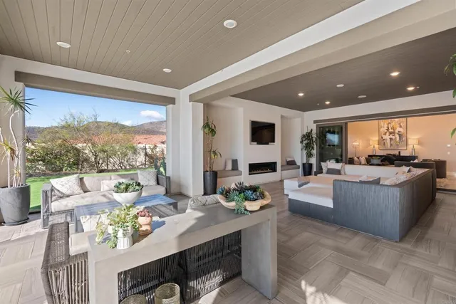 a large hall with lots of tables a large window and chairs