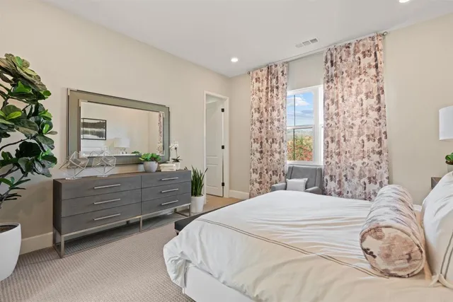 a large bathroom with a tub a double vanity sink a mirror a and a large window