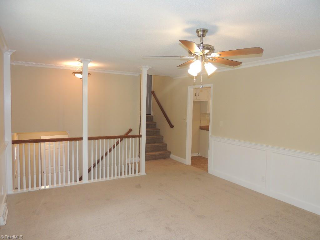 5309 Mapleton Street Clemmons, NC 27012 - Photo 8 of 19 Living Room has Wainscoting, Crown Molding, and a ceiling fan!