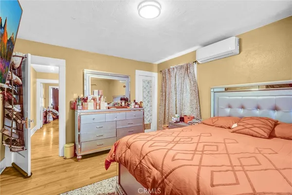 a bedroom with a large bed and a dresser
