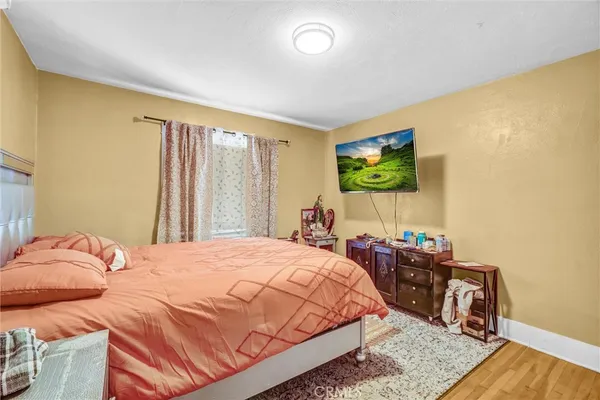 a bedroom with a bed and a flat screen tv