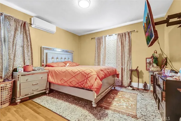 a bed room with a bed and a chair
