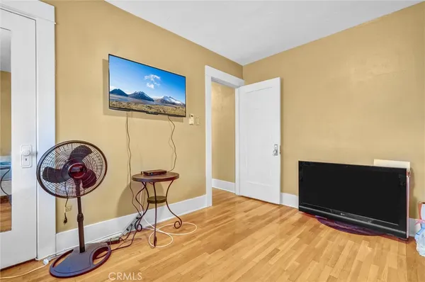 a view of a room with wooden floor and lounge chair