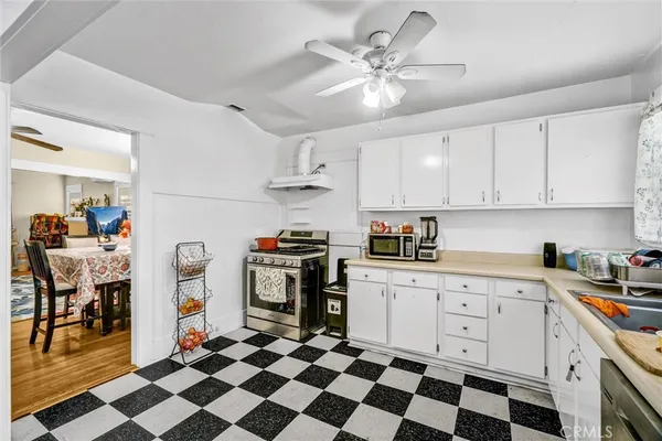 a kitchen with stainless steel appliances a stove a sink and a refrigerator