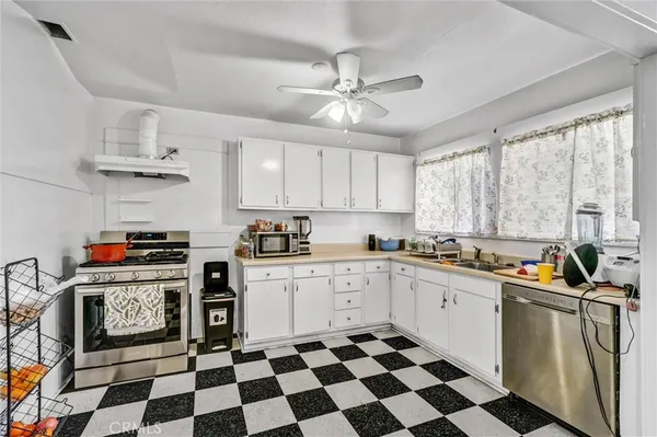 a kitchen with stainless steel appliances a stove a sink and a refrigerator