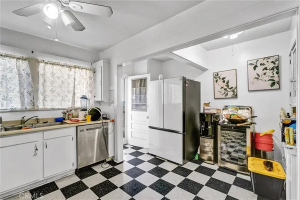 a kitchen with a checkered floor and a refrigerator