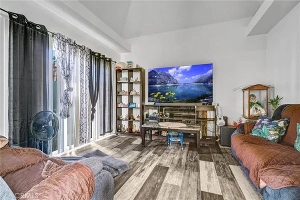 a bedroom with furniture and a flat screen tv