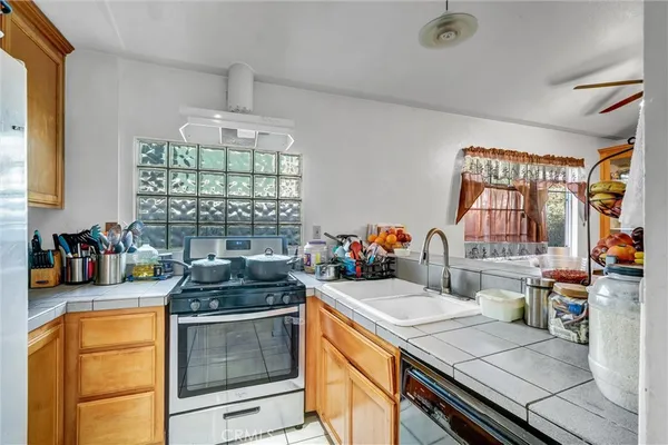 a kitchen with a sink stove and cabinets