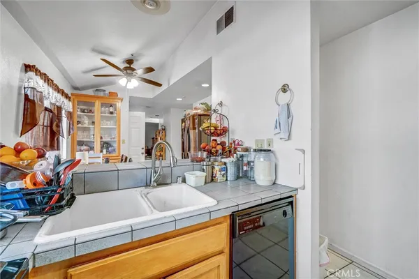 a view of a kitchen with appliances and a chandelier