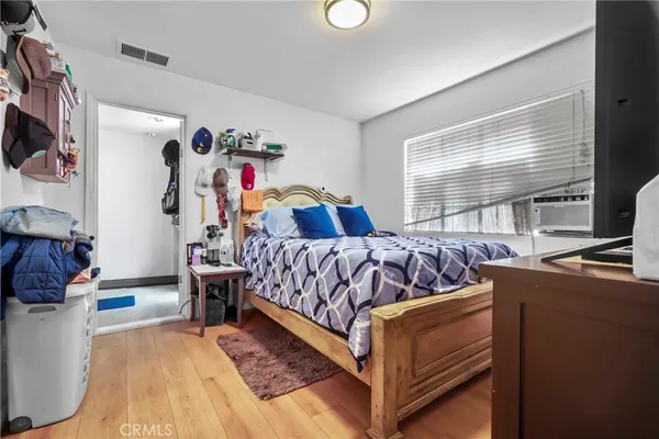 a bedroom with bed and a window