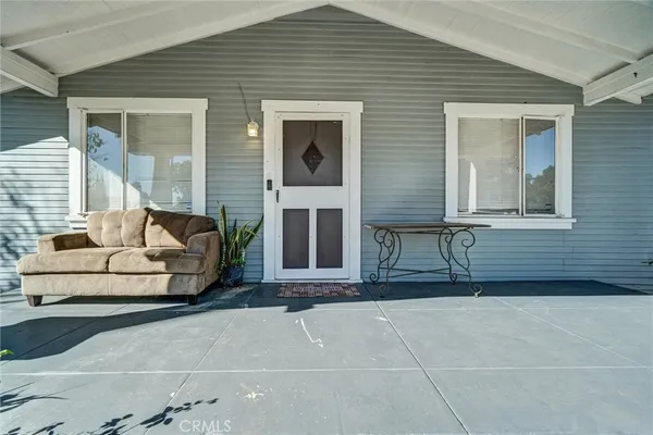 a building outdoor space with glass door and furniture