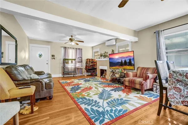 a living room with furniture a flat screen tv and a table