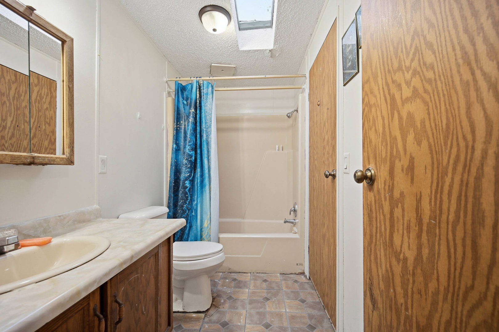 1300 West Branch Road Northfield, IL 60093 - Photo 11 of 25 a bathroom with a granite countertop sink toilet and shower