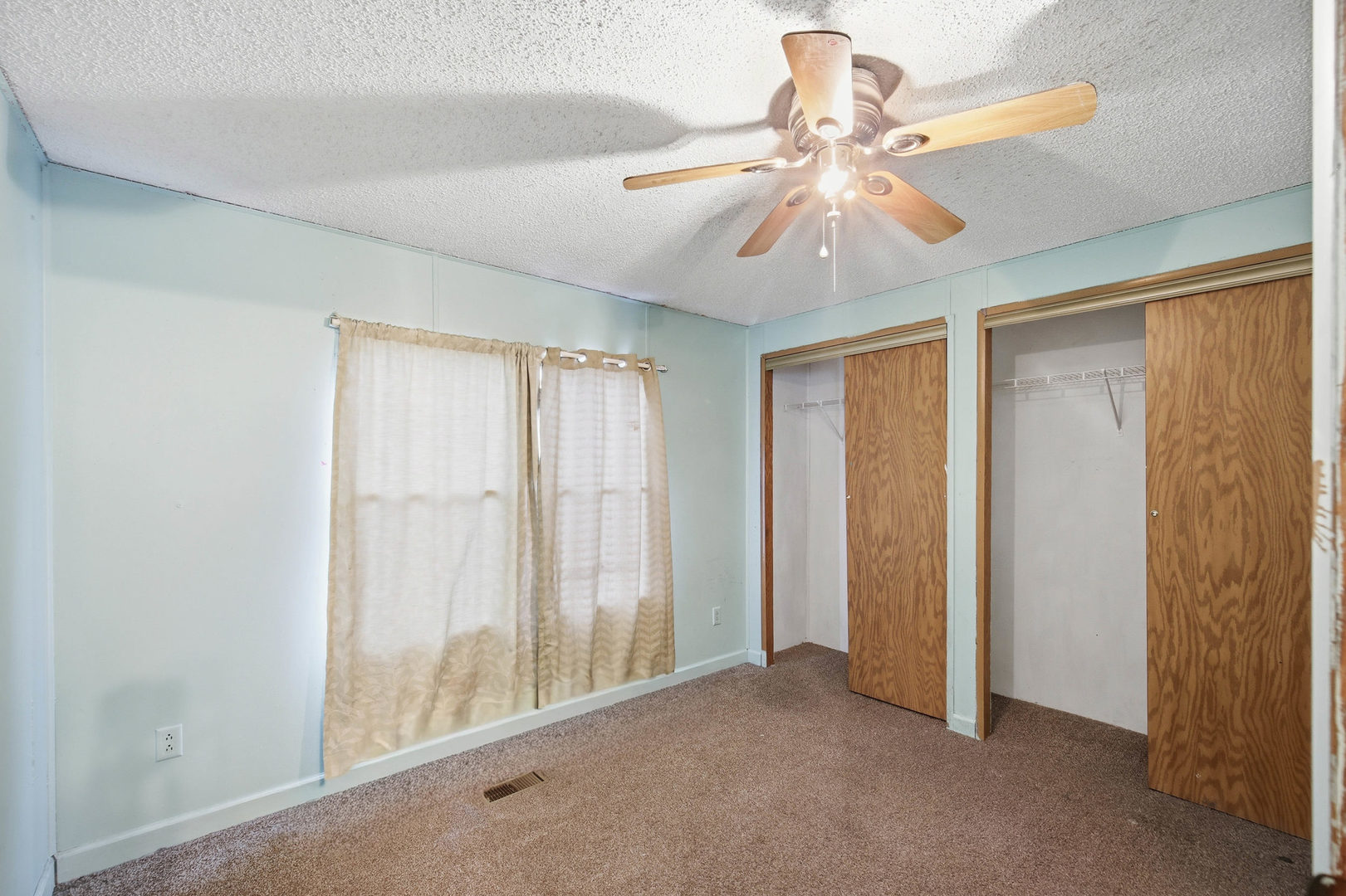 1300 West Branch Road Northfield, IL 60093 - Photo 14 of 25 an empty room with chandelier fan and windows