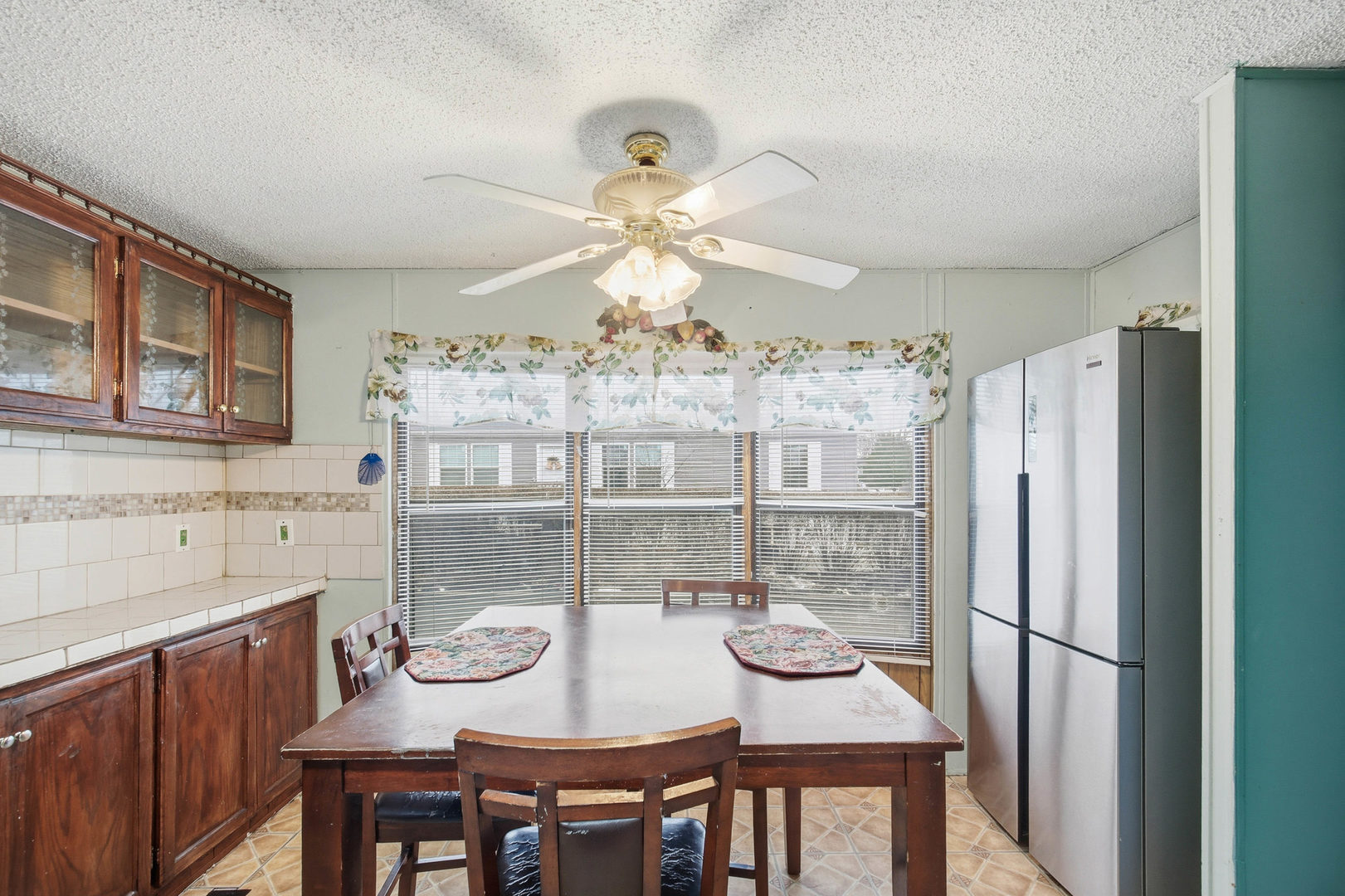 1300 West Branch Road Northfield, IL 60093 - Photo 4 of 25 a kitchen with stainless steel appliances granite countertop a refrigerator a sink a stove and chairs