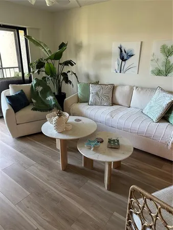 a living room with furniture and a potted plant