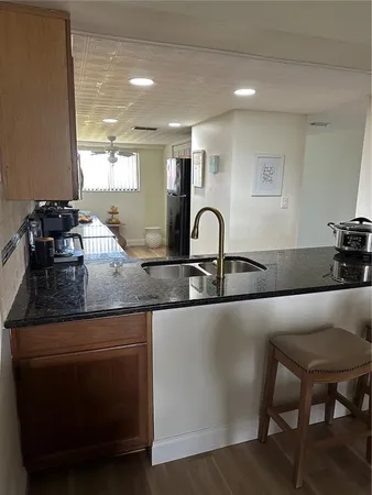 a kitchen with a sink and chairs