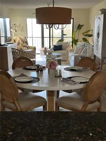 a kitchen with a table chairs and a dining table
