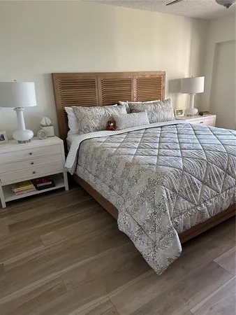 a bedroom with a bed and a night stand