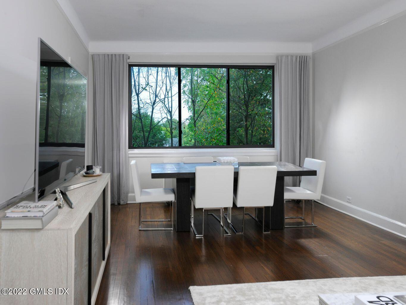 47 Lafayette Place, Unit 3H Greenwich, CT 06830 - Photo 4 of 13 a view of a dining room with furniture and wooden floor