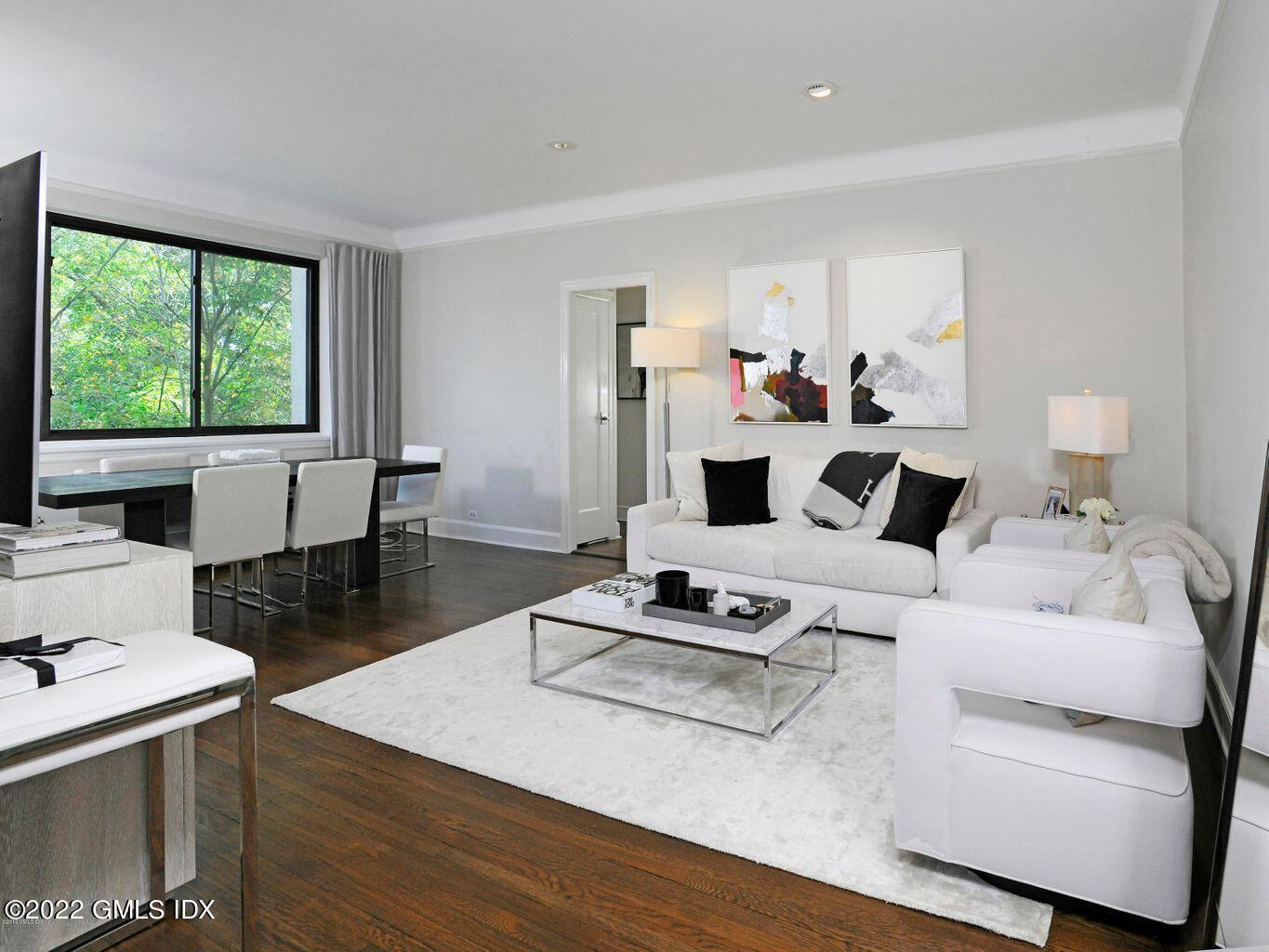 47 Lafayette Place, Unit 3H Greenwich, CT 06830 - Photo 5 of 13 a living room with furniture hard wood floor and a table