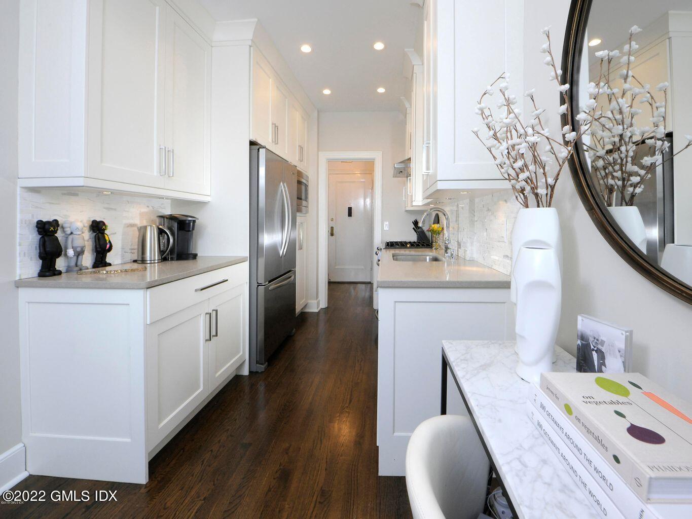 47 Lafayette Place, Unit 3H Greenwich, CT 06830 - Photo 6 of 13 a kitchen with a sink a refrigerator and cabinets