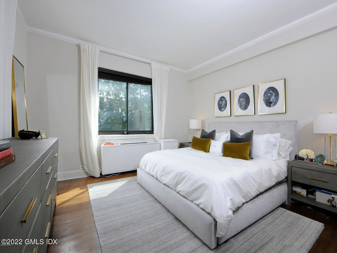 47 Lafayette Place, Unit 3H Greenwich, CT 06830 - Photo 8 of 13 a bedroom with a large bed and a window