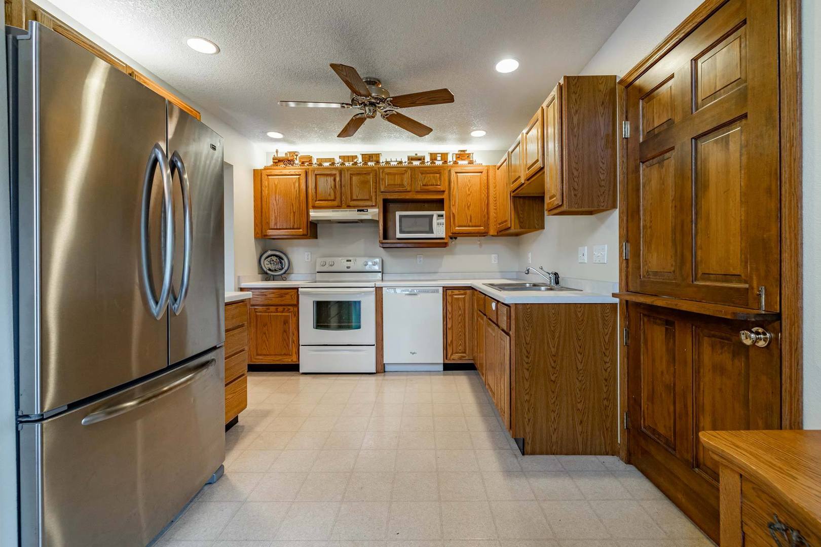 17501 Bishop Road Morrison, IL 61270 - Photo 78 of 167 a kitchen with stainless steel appliances granite countertop a refrigerator a sink dishwasher and a stove