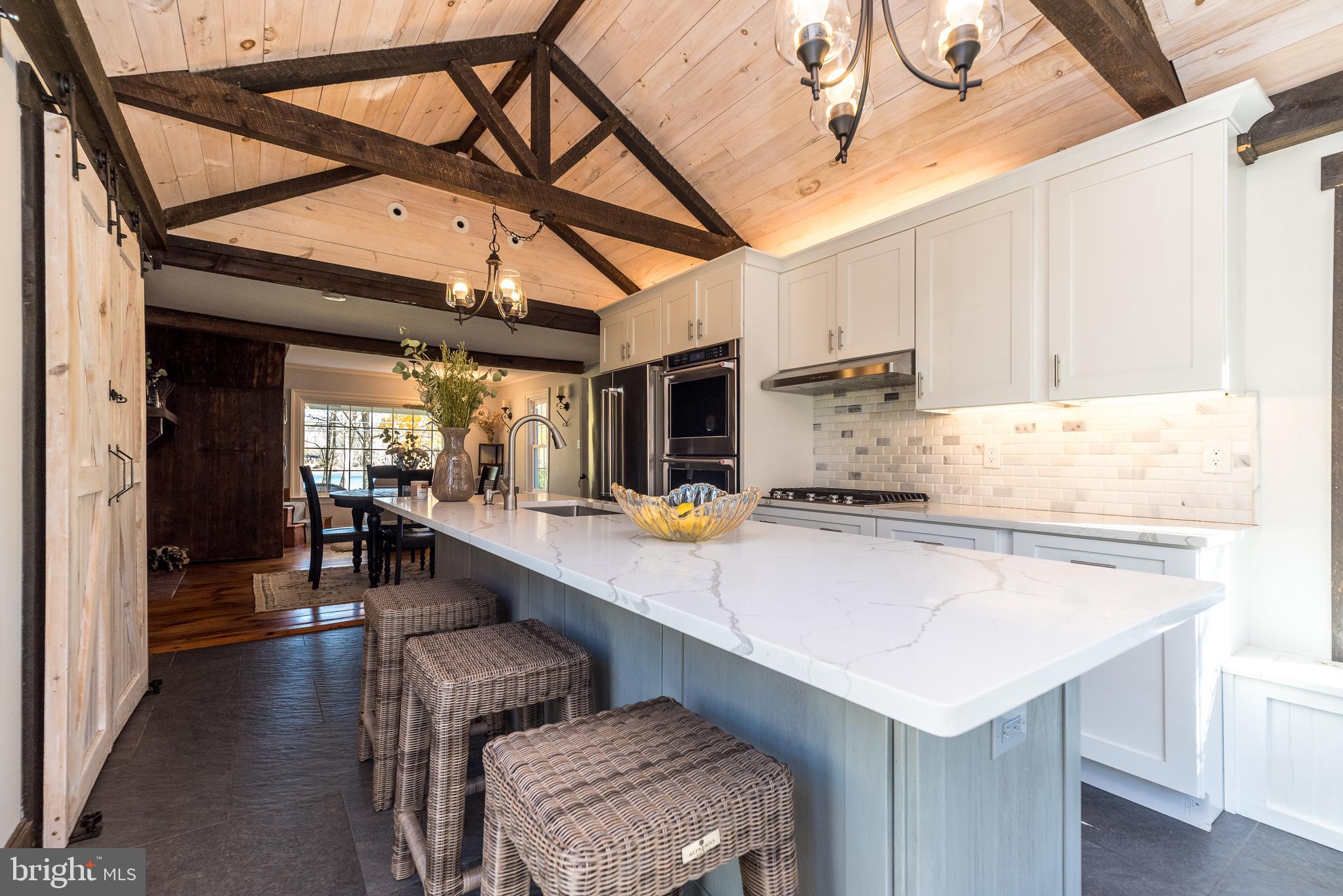 1442 River Road Upper Black Eddy, PA 18972 - Photo 14 of 65 a kitchen with a sink a stove and chairs