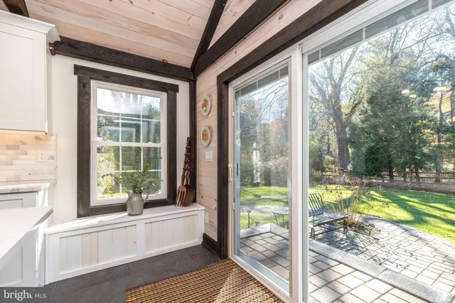 a bathroom with a tub that has a large window