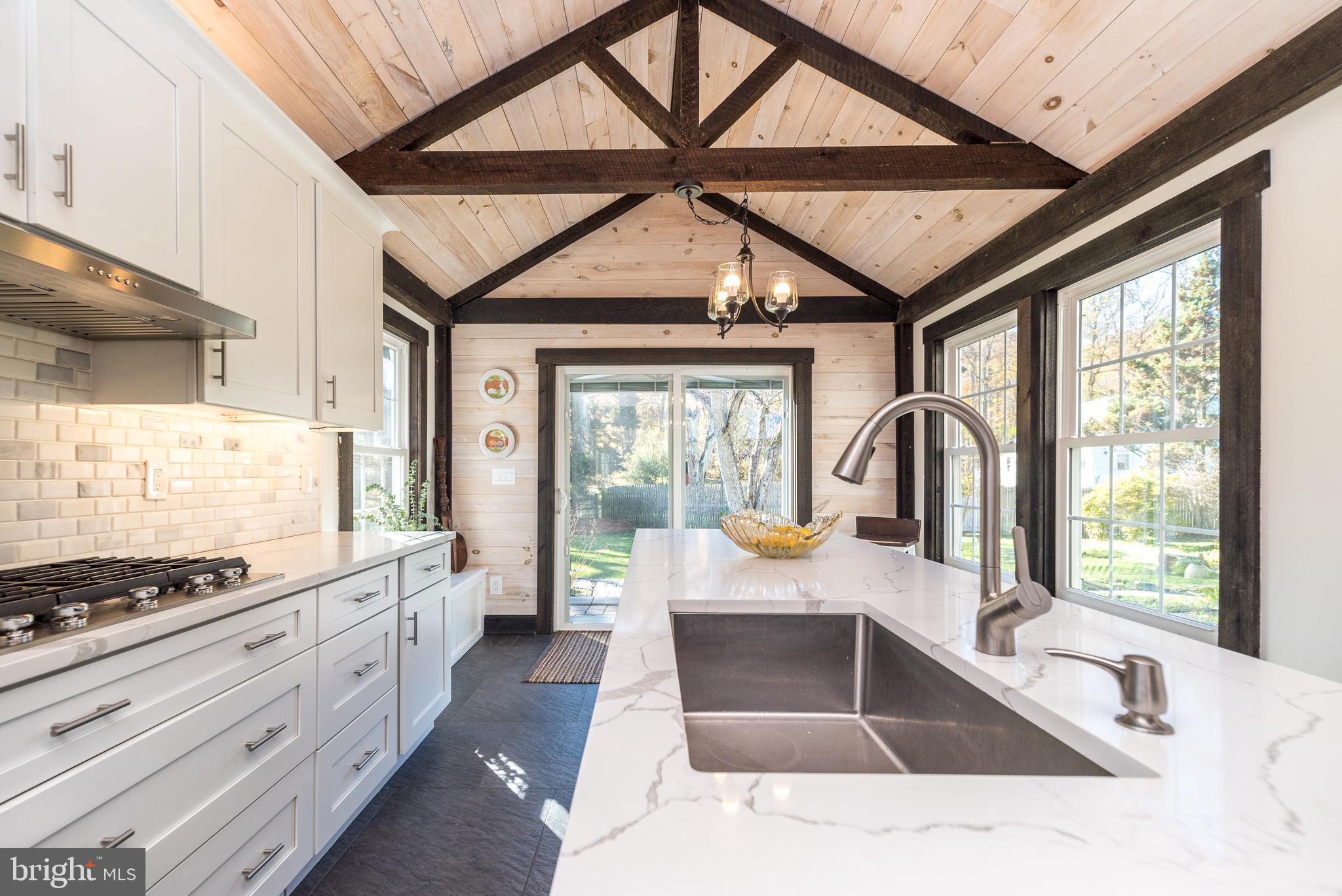 1442 River Road Upper Black Eddy, PA 18972 - Photo 18 of 65 a large kitchen with a large window and stainless steel appliances