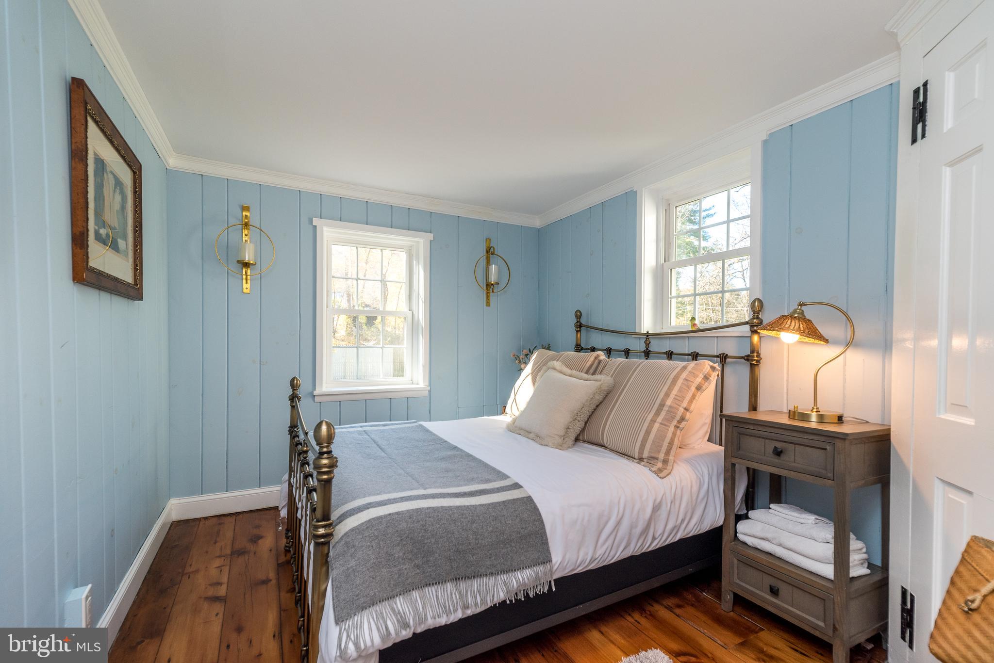 1442 River Road Upper Black Eddy, PA 18972 - Photo 41 of 65 a bedroom with a bed and wooden floor