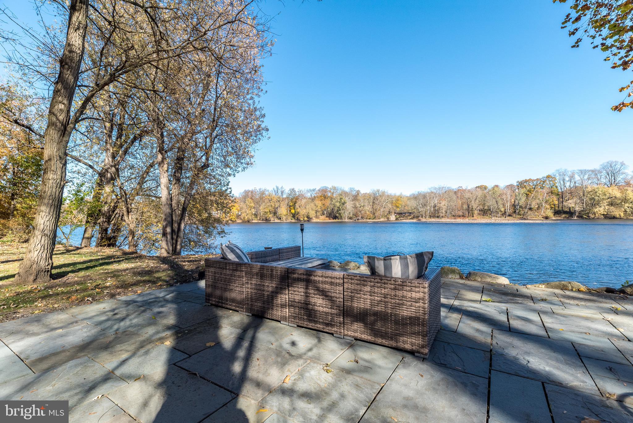 1442 River Road Upper Black Eddy, PA 18972 - Photo 44 of 65 a view of a lake with couches in the patio