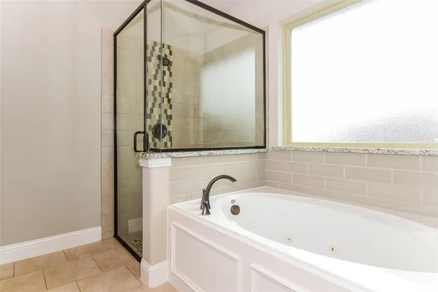 a bathroom with a bathtub and a shower