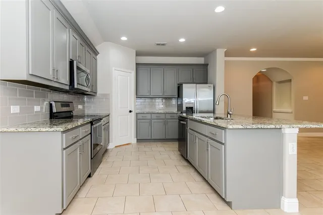 a kitchen with stainless steel appliances granite countertop a sink and cabinets